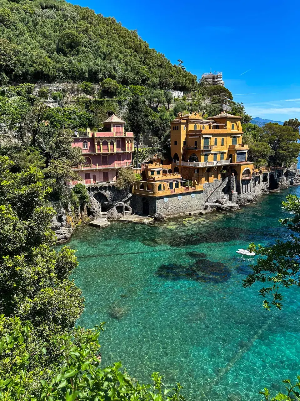 A turquoise coastal cove lined with colourful buildings
