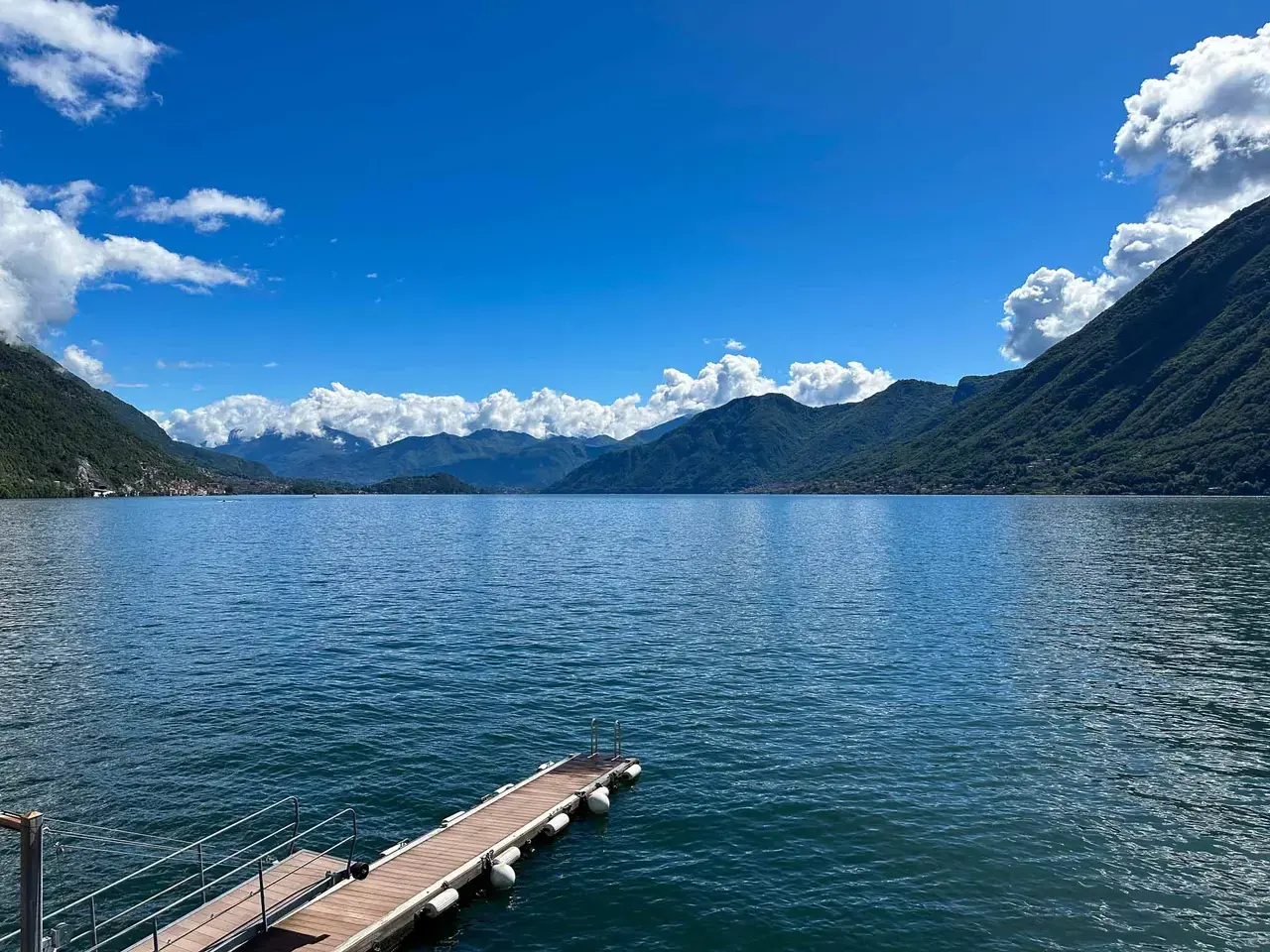 A wide alpine lake under a bright sky