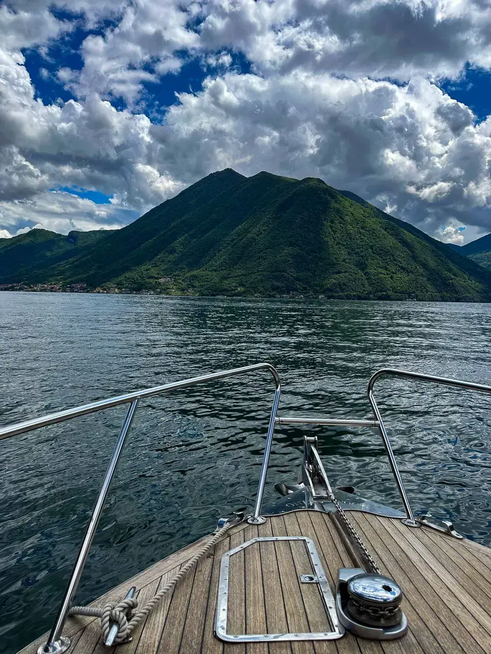 A jetty on the lake beneath hazy mountains