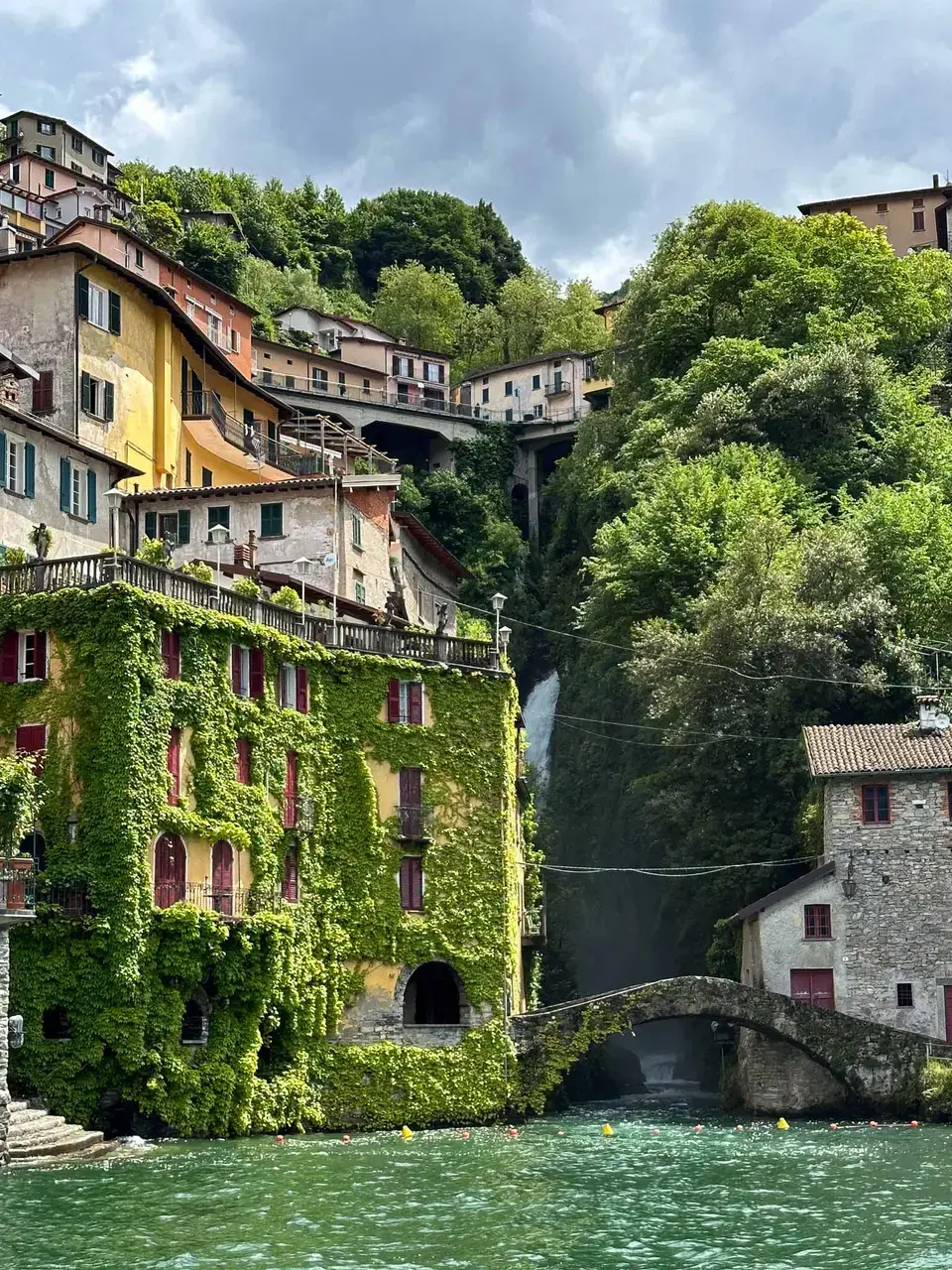 A town rising up a steep slope beside the lake