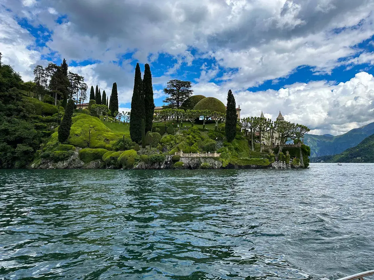A lakeside village with a church tower at the water's edge