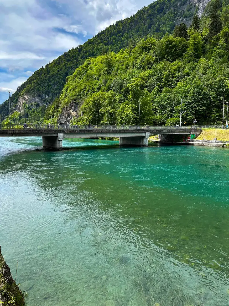 A turquoise lake between steep forested mountains