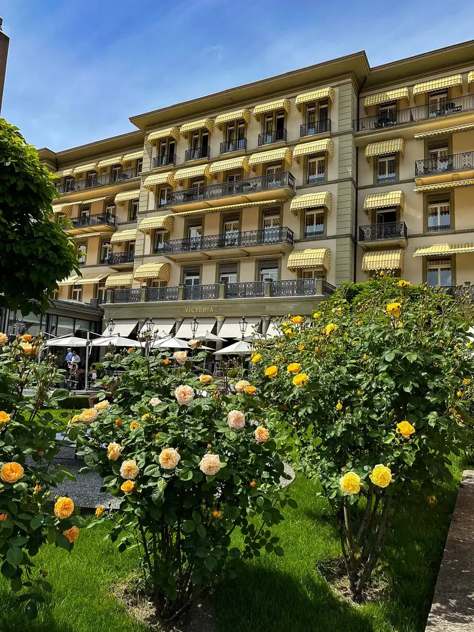 A grand alpine hotel surrounded by mountains