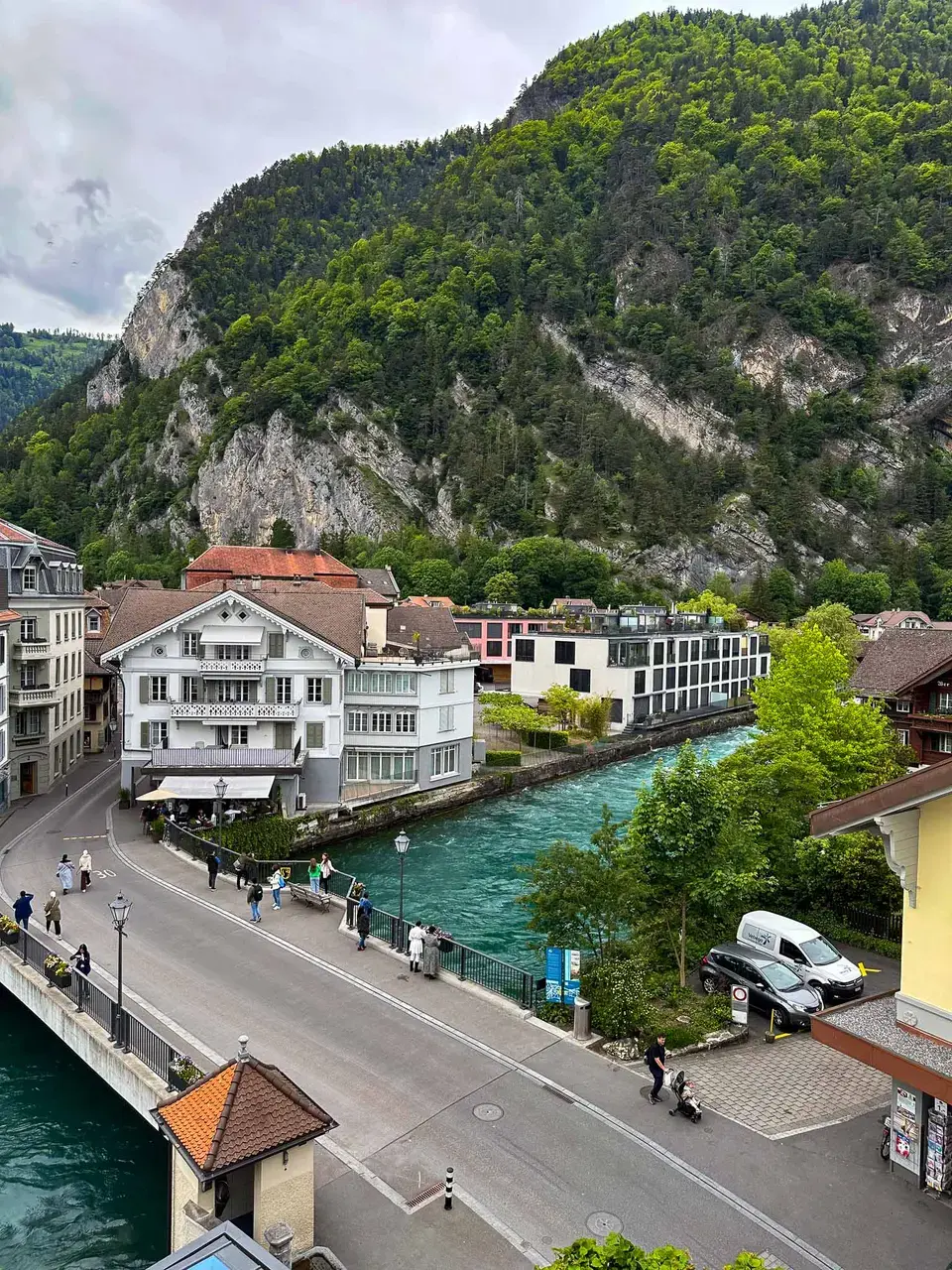 A lakeside town with mountains rising behind