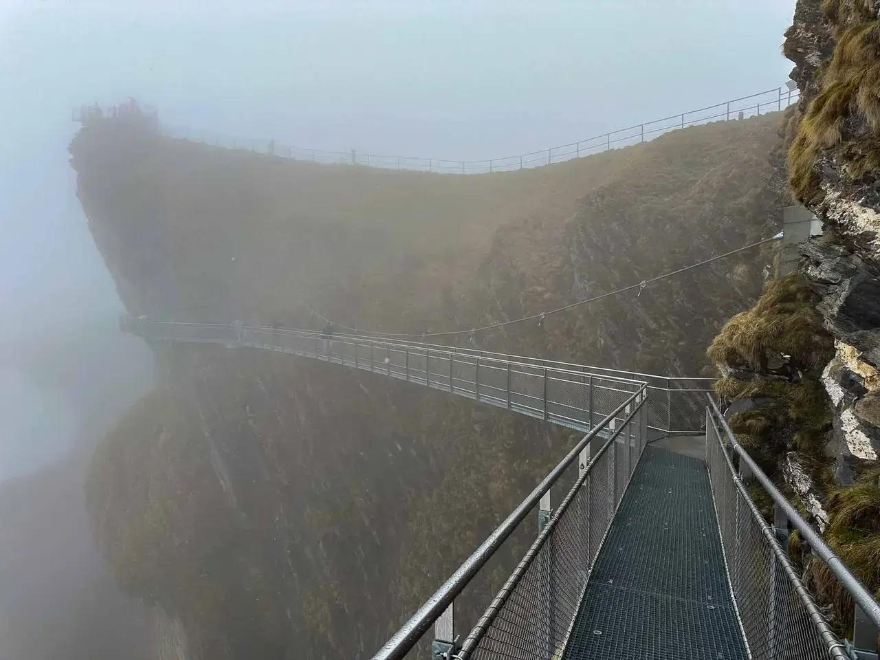 A walkway along a misty mountain cliff