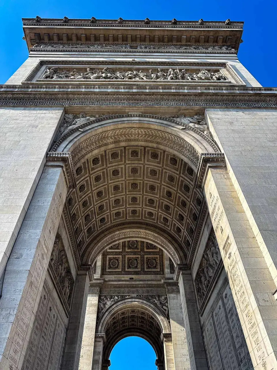 A carved stone archway against a blue sky