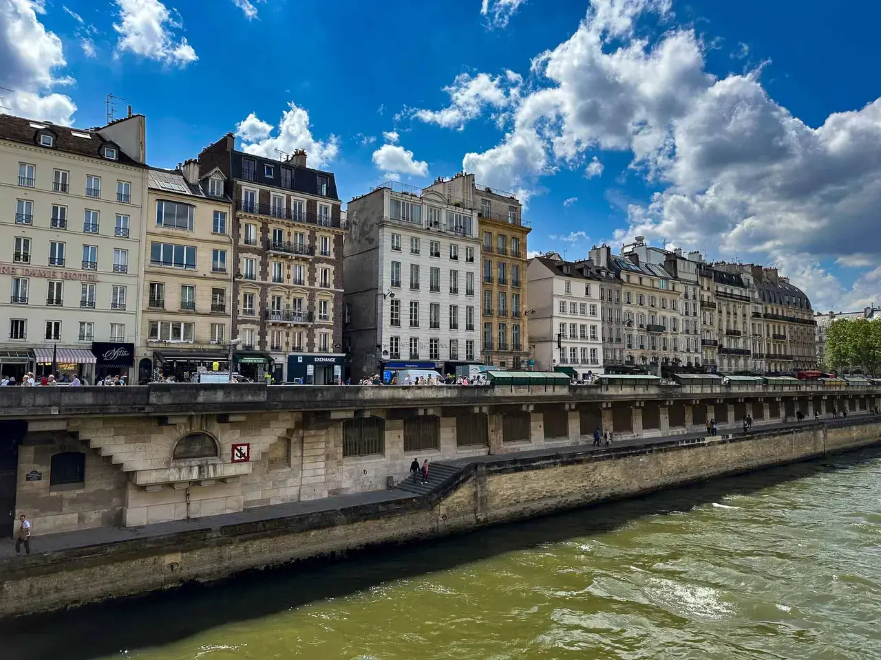 A river running through a city lined with buildings