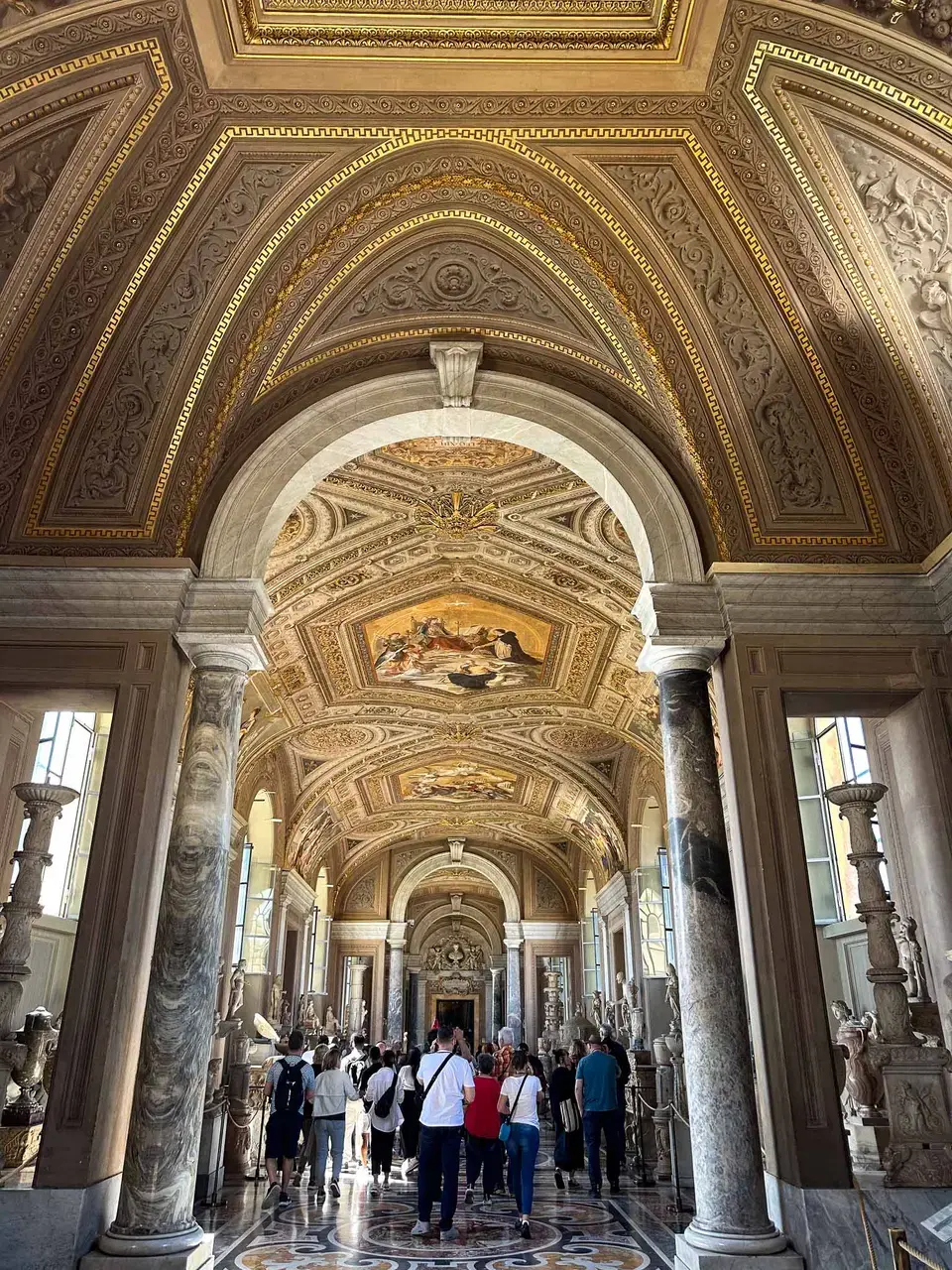 The frescoed, arched interior of an ornate cathedral