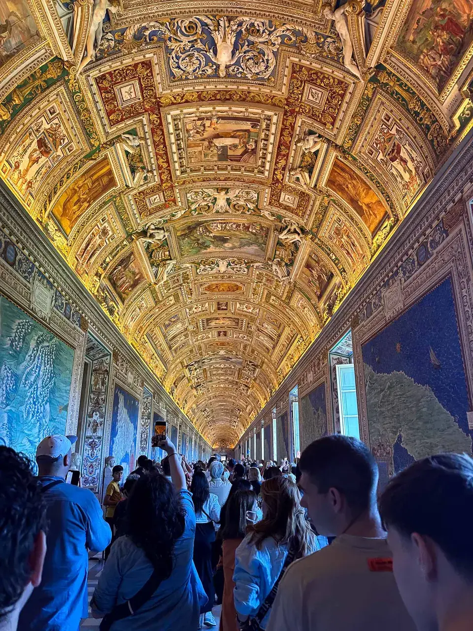 An ornate gilded mosaic ceiling inside a basilica