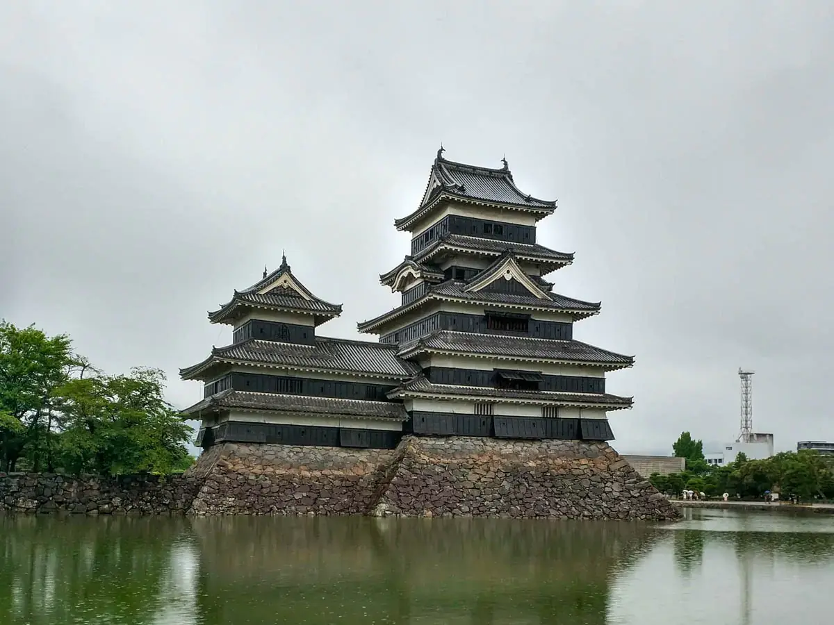 Photograph of Matsumoto Castle reflected in its moat in Japan